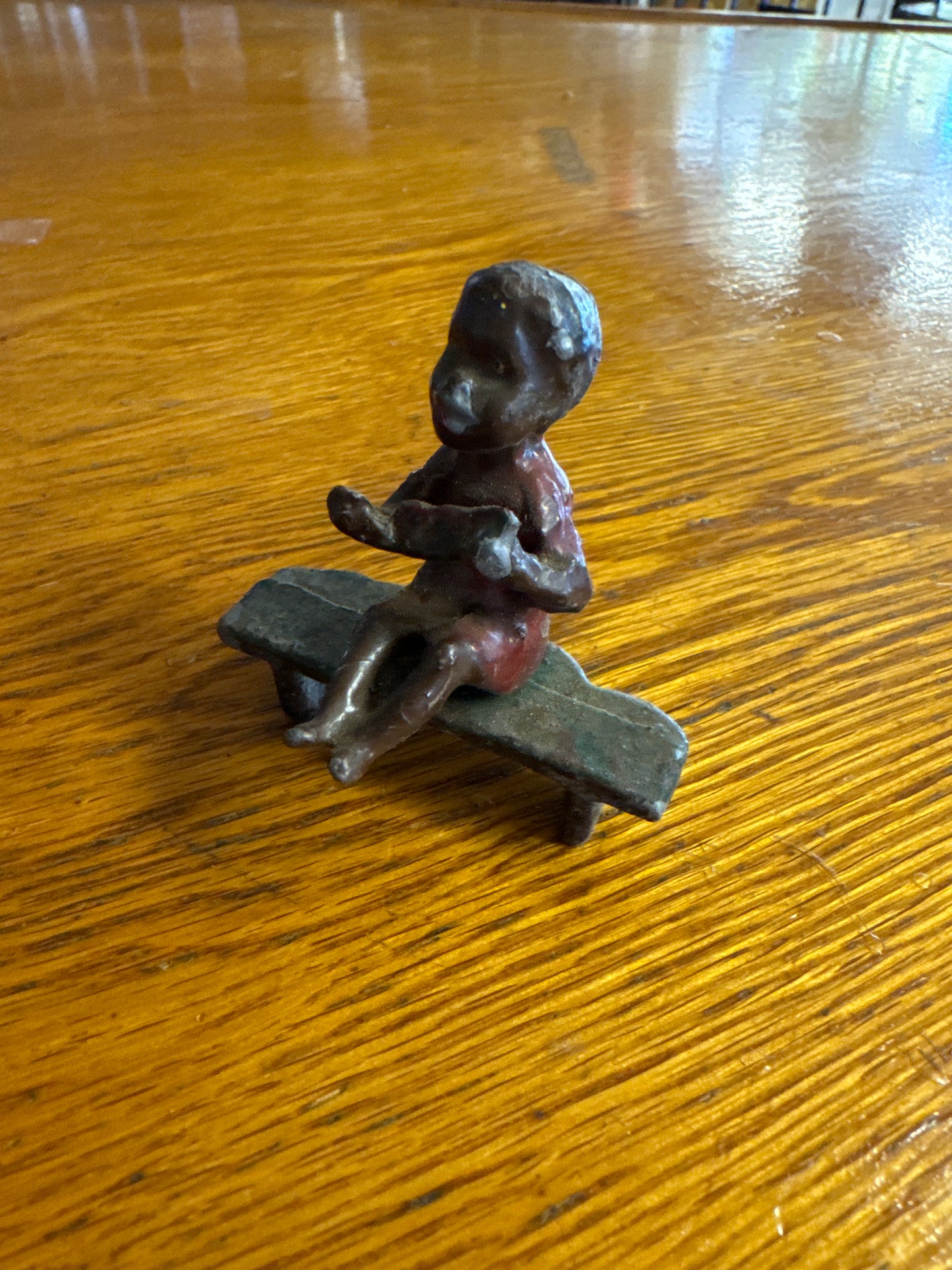 Lead Black Americana Boy Sitting on Bench