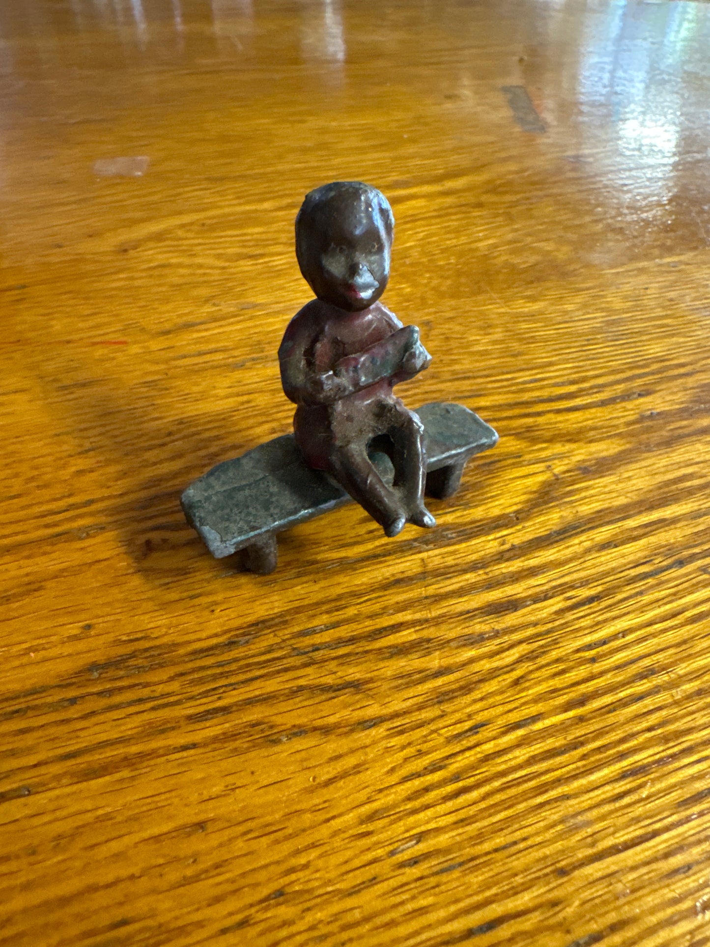 Lead Black Americana Boy Sitting on Bench