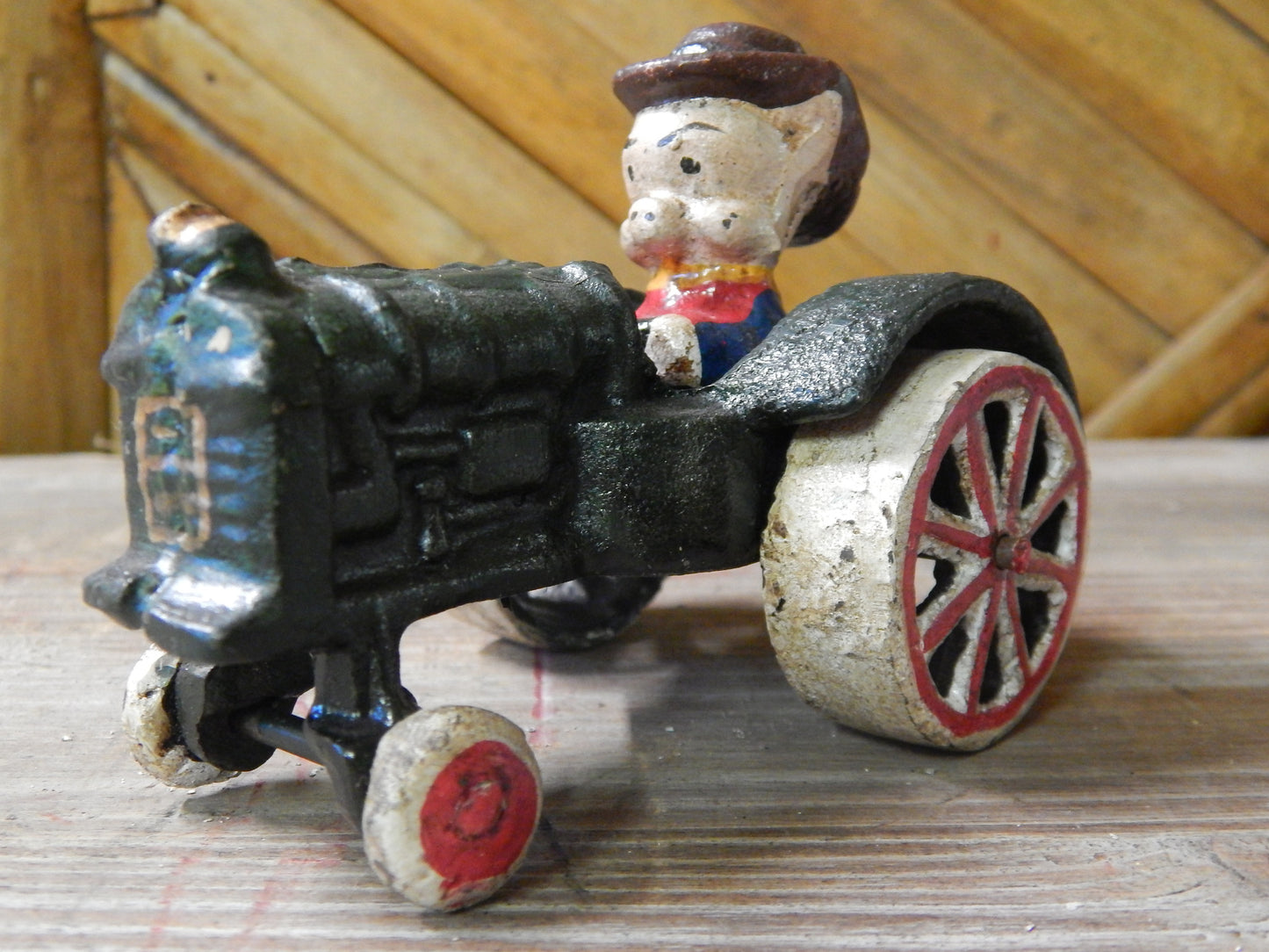 Cast Iron Figurine - Porky Pig on Farm Tractor